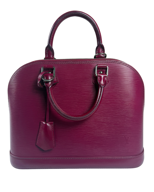 A Louis Vuitton Alma handbag in magenta Epi leather, featuring dual top handles, silver-tone hardware, and a hanging leather tag, set against a plain white background.