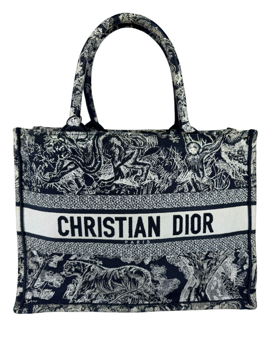 Christian Dior Tote bag featuring a navy blue and white classic Dior Oblique print, with a prominent white horizontal band across the center displaying 'CHRISTIAN DIOR PARIS' in black text.